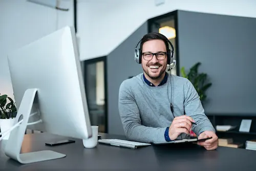 A manubes support employee at their workstation